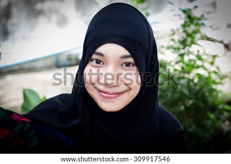 Young Asian muslim woman in head scarf