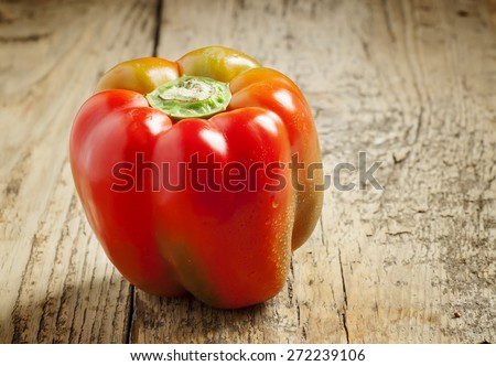 bell pepper with water drops on a wooden table