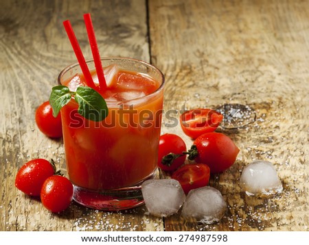 Red cocktail with tomato juice, ice and salt, selective focus