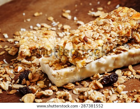 Bar muesli and spilled cereal with raisins, selective focus