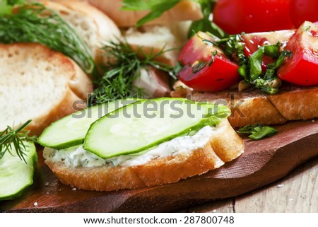 Two types of sandwiches: tomato and cucumber, selective focus