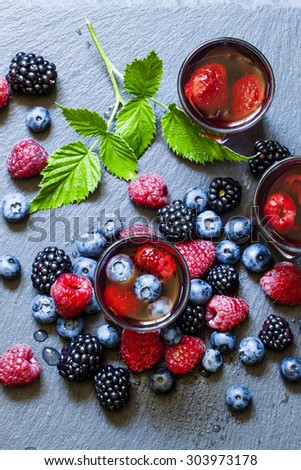 Juice of wild berries on a dark background, top view, selective focus