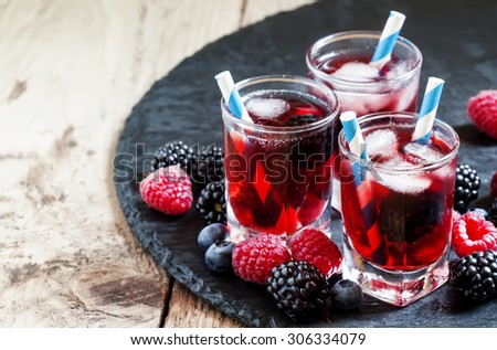 Berry icy cocktail with blueberries, blackberries and raspberries, selective focus