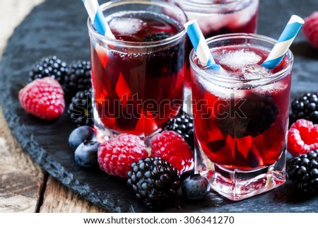 Berry icy cocktail with blueberries, blackberries and raspberries, selective focus