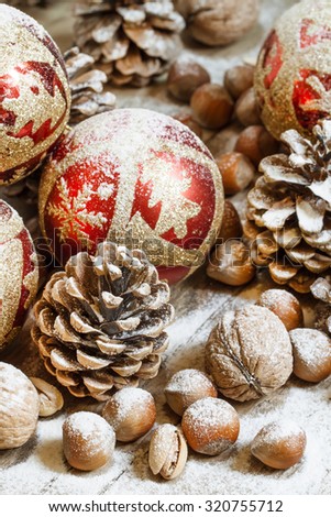 Christmas background with snow-covered fir cones, Christmas balls, nuts, selective focus