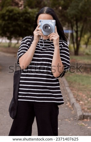 Similar – Foto Bild Junge Frau hält Polaroid Bild von sich in die Kamera