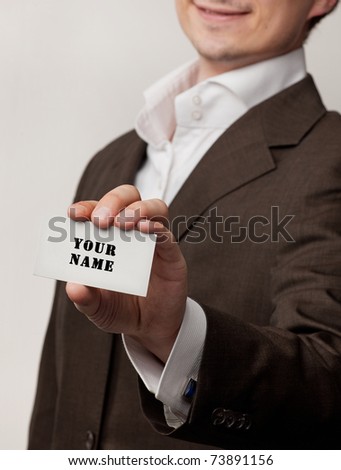Businessman show white visit card isolated in studio
