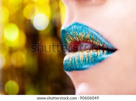 Glamour Green Gold gloss lips moving up on the bright background, shallow focus