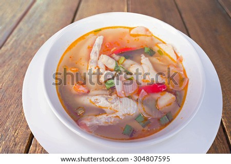 Chicken finger spicy soup  on wood table