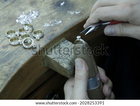 Similar – Image, Stock Photo Mature jeweler creating gold item using a pencil in workshop