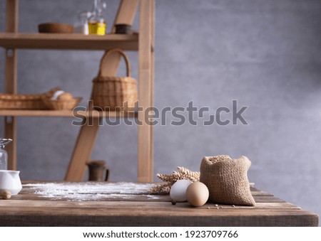 Bakery ingredients for homemade bread cooking or baking on table. Food set at wooden tabletop near wall background texture with copy space. Front view of bakery concept