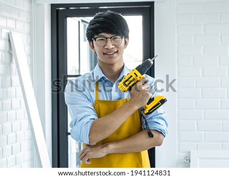 Portrait of Craftsman doing renovation work at home improvement with holding drill and interior design concept.