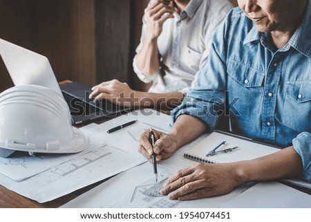 Construction and structure concept of Engineer or architect meeting for project working with partner and engineering tools on model building and blueprint in working site, contract for both companies.