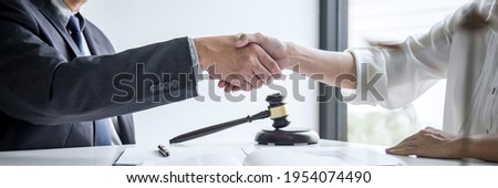 Good service cooperation of Consultation between a male lawyer and business woman customer, Handshake after good deal agreement, Law and Legal concept.