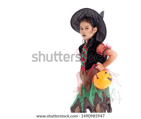 Asian little girl in costume of witch isolated on white background. Happy halloween concept.