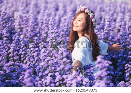 Portrait image of an asian woman in a beautiful Margaret flower field