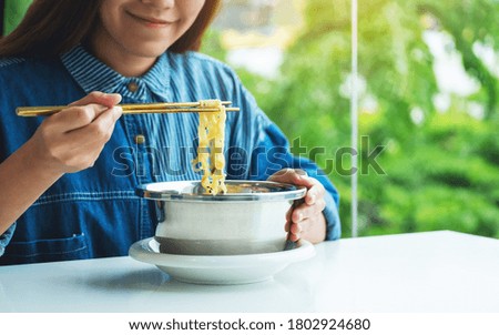 Similar – Image, Stock Photo Young female eating noodles and watching TV