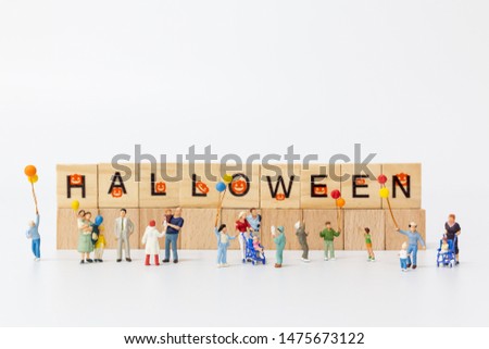 Miniature people:  Happy family holding balloon and copy space for text, Happy Halloween concept