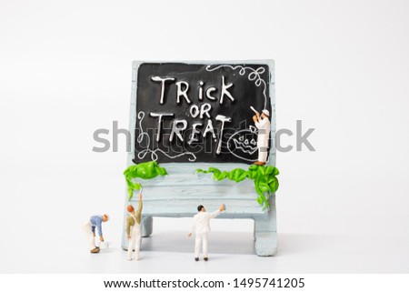 Miniature people coloring Halloween Party Props Decoration on a white background , Halloween party concept