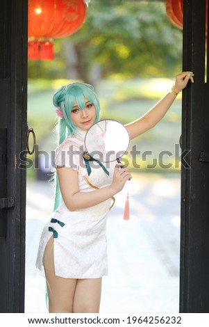 Japan anime cosplay portrait of a girl with chinese dress costume in chinese garden