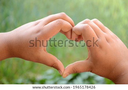A closeup of hands showing a heart shape - mental health awareness concept