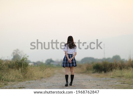 beautiful asian japanese school girl uniform looking at park outdoor 