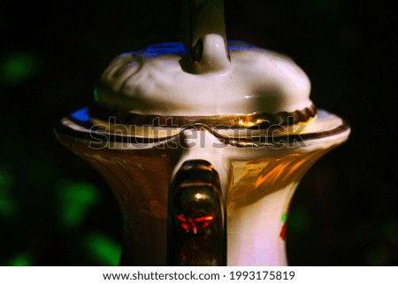 A closeup shot of a teapot on dark background