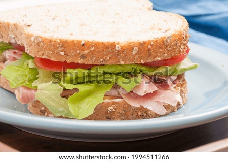A whole-wheat rosemary ham sandwich for taking out or takeaway