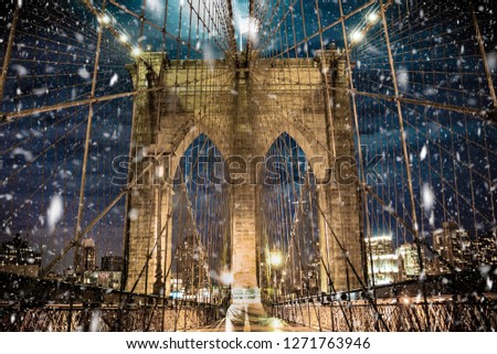 Brooklyn Bridge New York City with snowflakes falling during winter snow storm