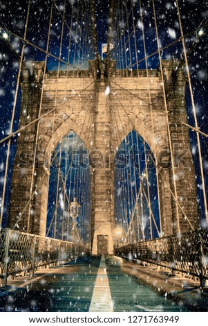 Brooklyn Bridge New York City with snowflakes falling during winter snow storm