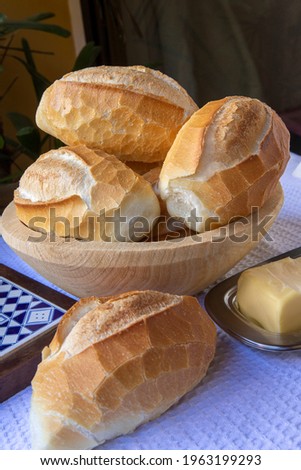 Basket of French bread, traditional Brazilian bread, with butter for breakfast.
