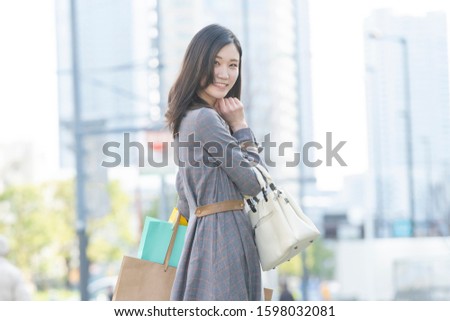 young woman has shopping bags