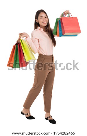 Happy young asian woman with shopping bags isolated on a white background.