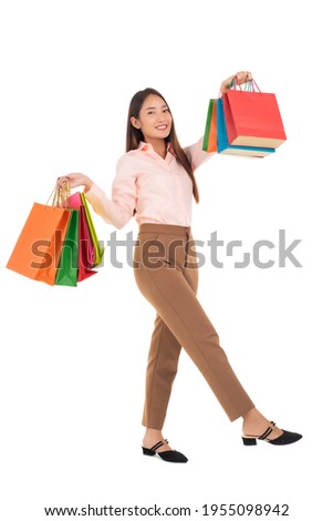 Happy young asian woman with shopping bags isolated on a white background.