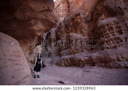 Young woman in black dress in Solomonn Pillars, Timna park, Israel/ Fantasy consept