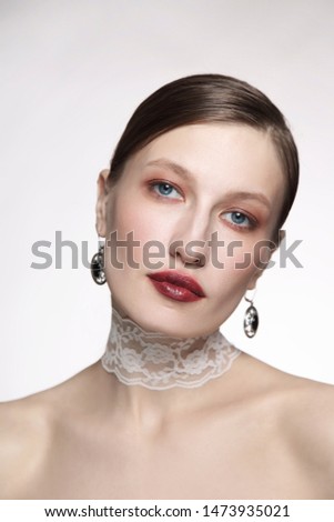 Vintage style portrait of young glamorous woman with fancy makeup and lace chocker