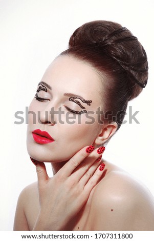 Vintage style portrait of youngbeautiful woman with fancy makeup and hair bun 