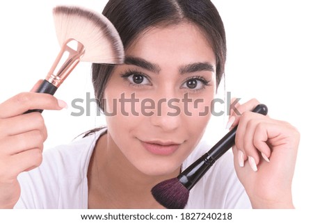 beautiful young smiling woman apply makeup with brush. isolated