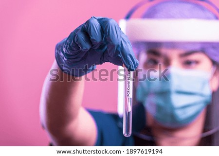 COVID-19 PCR test in researcher hands, female doctor holds test for coronavirus. Concept of corona virus treatment, injection, shot and clinical trial during pandemic.