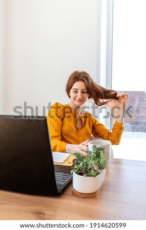 Defocus. Young woman is undergoing psychotherapy on the Internet using a computer. Girl looks into a laptop computer. People wellness and mental health concept. Comfort zone in the house.