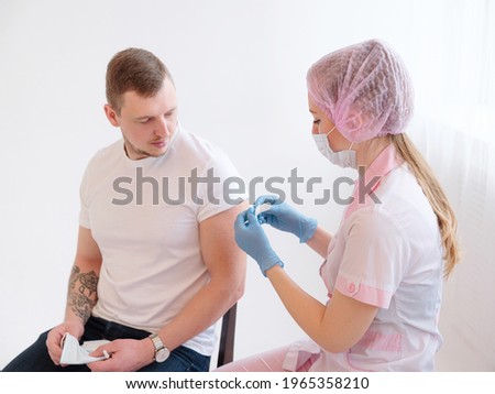 Doctor making a vaccination in the shoulder of patient, Flu Vaccination Injection on Arm, coronavirus, covid-19 vaccine disease preparing for human clinical trials vaccination shot.