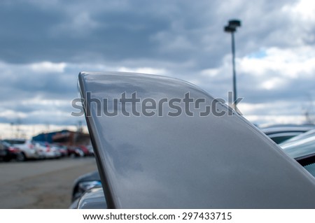 Abstract car fin with cloudy sky background. Flying through the sky. Abstract industrial park.  Parking lot. Car parking area. Car trunk abstract.