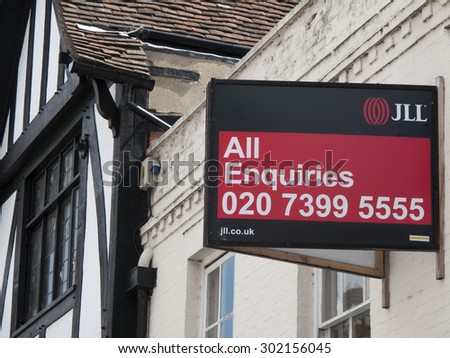 Winchester High Street, Hampshire, England - July 31, 2015: Estate agent to let signs over properties advertising vacant retail premises