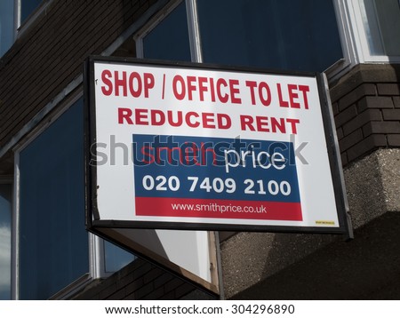Newbury, Market Place, Berkshire, England - August 07, 2015: Shop office to let with reduced rent advertising sign over vacant premises