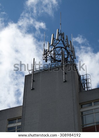 Newbury, Berkshire, England - August 21, 2015: Mobile phone and telecommunication transmitters on building roof