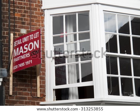 Winchester, High Street, Hampshire, England - September 4, 2015: Commercial estate agent to let sign over vacant retail units