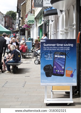 Winchester High Street, Hampshire, England - July 31, 2015: O2 mobile phone shop sign on the busy main shopping street