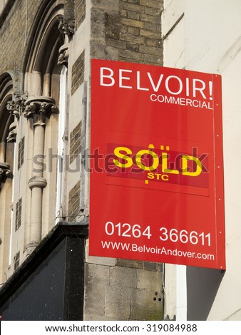 Andover, High Street, Hampshire, England - September 21, 2015: Commercial office units sold sign over retail shops