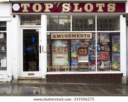 Andover, High Street, Hampshire, England - September 21, 2015: Top Slots Amusement Arcade, late rain soaked afternoon