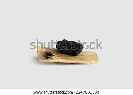 Black decorative stone on a wooden board Imagine de stoc © 